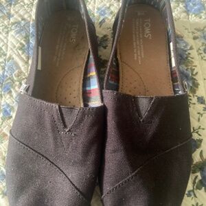 Tom’s black on black canvas flats